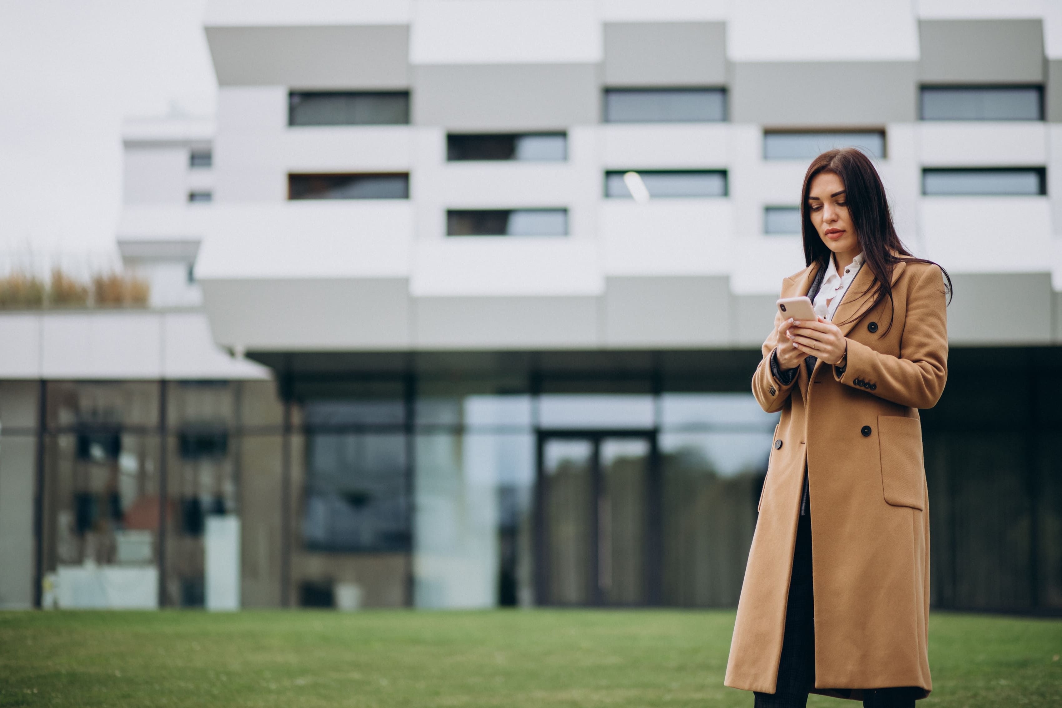 Professional woman using phone for property analysis